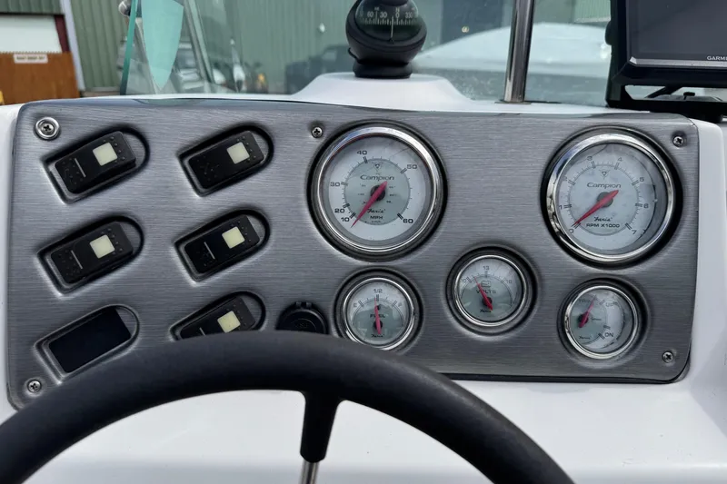 Slide: The Image of Dashboard of a 2005 Campion Explorer 582 Center Console with gauges and switches. - 5