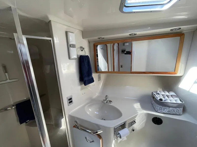 Slide: The Image of 1989 Sea Ray 420 yacht bathroom with sink, mirror, and shower. - 15