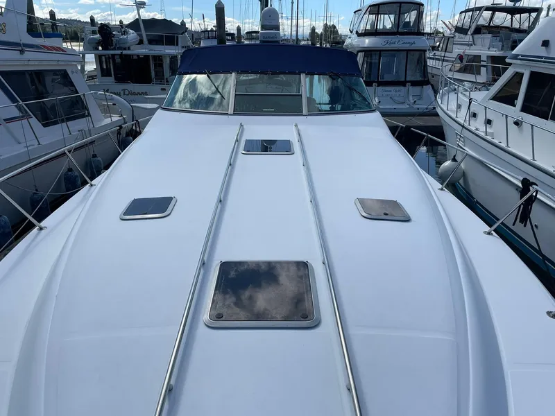 Slide: The Image of 1989 Sea Ray 420 yacht docked among other boats at a marina. - 7