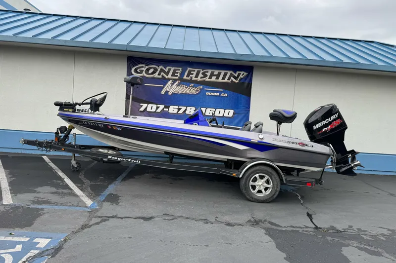 The Image of 2017 Ranger Z185 boat with Mercury engine on trailer, parked outside dealership. - 1