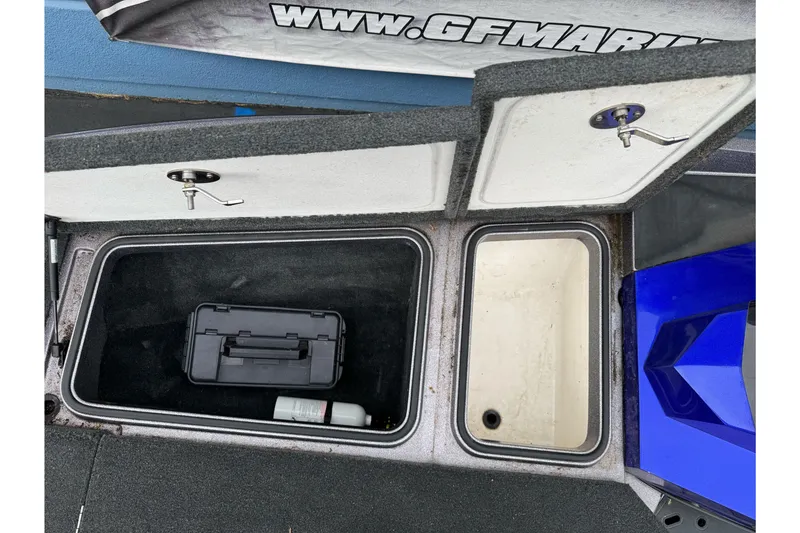 Slide: The Image of Open storage compartments on a 2017 Ranger Z185 boat, featuring a toolbox and bottle. - 14