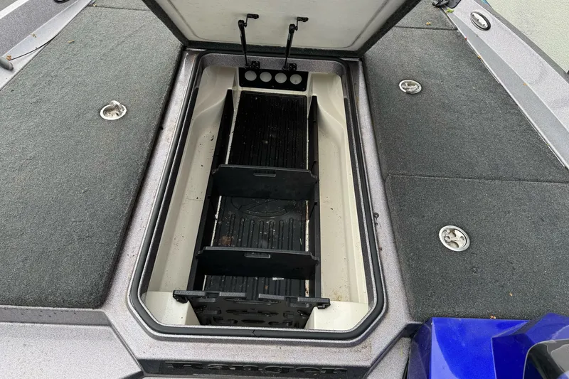 Slide: The Image of Open storage compartment in a 2017 Ranger Z185 boat, featuring organized interior layout. - 16