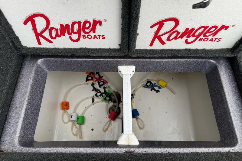 Slide: The Image of 2017 Ranger Z185 boat compartment with colorful fishing line markers. - 21