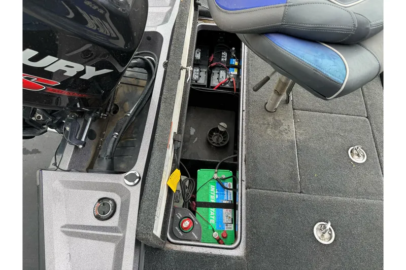 Slide: The Image of 2017 Ranger Z185 boat battery compartment with Mercury engine and seating. - 23