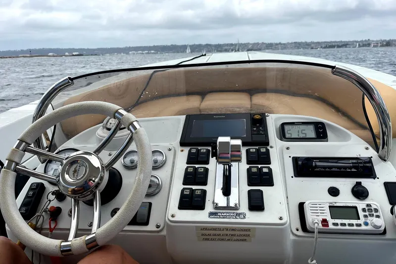 Slide: The Image of 2016 Castoldi jet tender dashboard with steering wheel and control panel on open water. - 2
