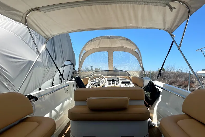 Slide: The Image of 2016 Castoldi jet tender interior with beige seating and steering console under canopy. - 3