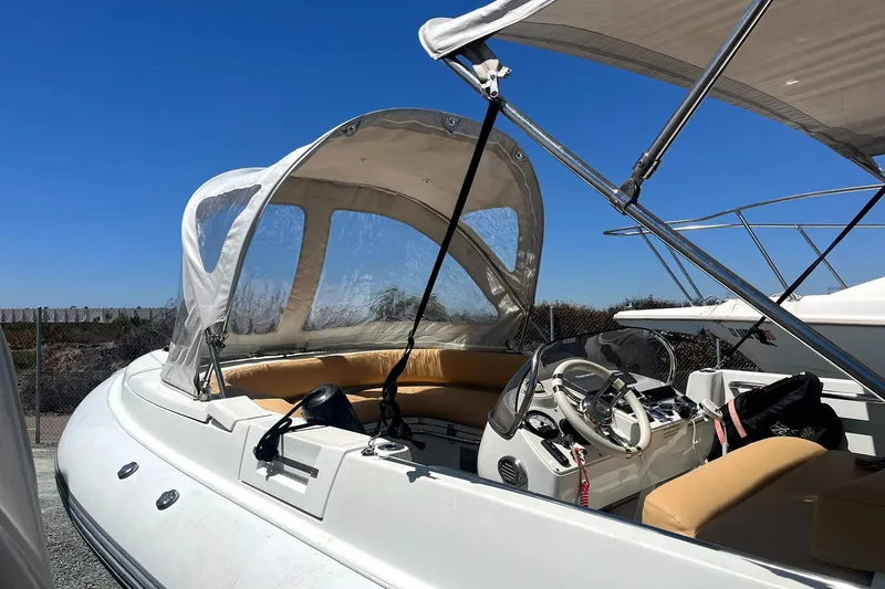 Slide: The Image of 2016 Castoldi jet tender with canopy and seating, docked under clear blue sky. - 5