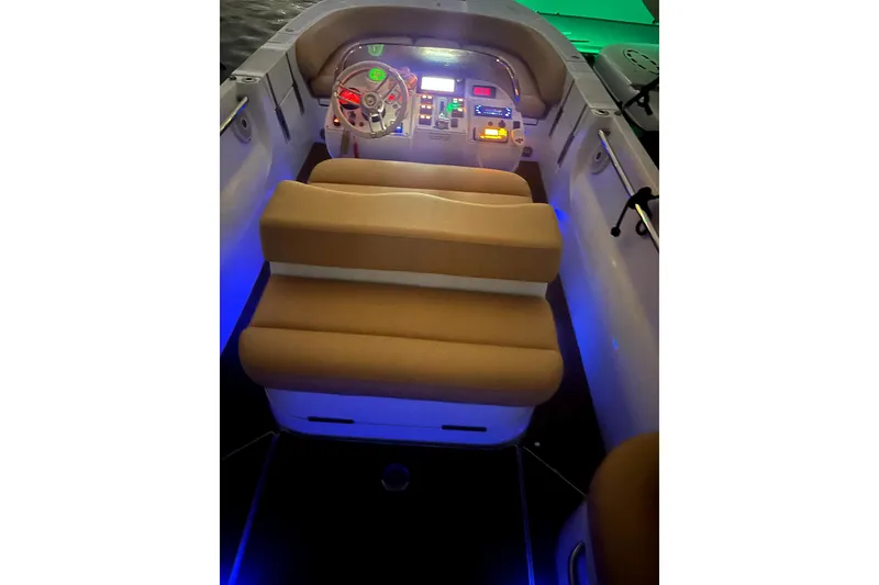 Slide: The Image of 2016 Castoldi jet tender interior with illuminated dashboard and beige seating. - 9
