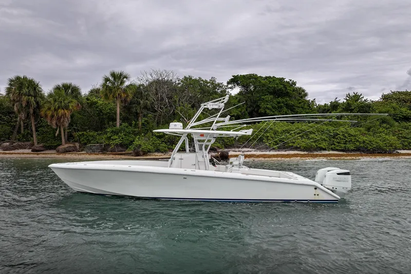 The Image of 2006 Venture Center Console boat on water near tropical shoreline. - 0
