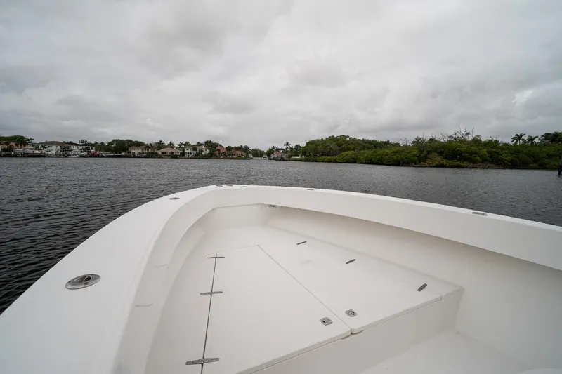Slide: The Image of 2006 Venture Center Console boat on calm water under cloudy skies. - 10