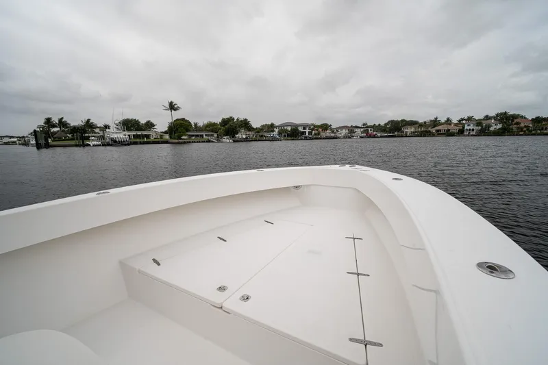 Slide: The Image of 2006 Venture Center Console boat on calm water under cloudy skies. - 11