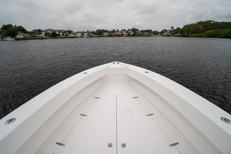 Slide: The Image of 2006 Venture Center Console boat on calm water with cloudy sky. - 12