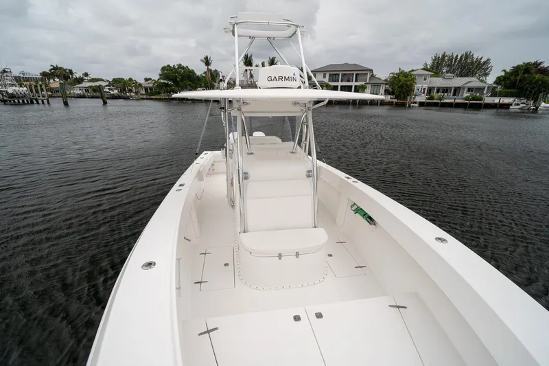Slide: The Image of 2006 Venture Center Console boat on calm water, featuring a Garmin navigation system. - 13