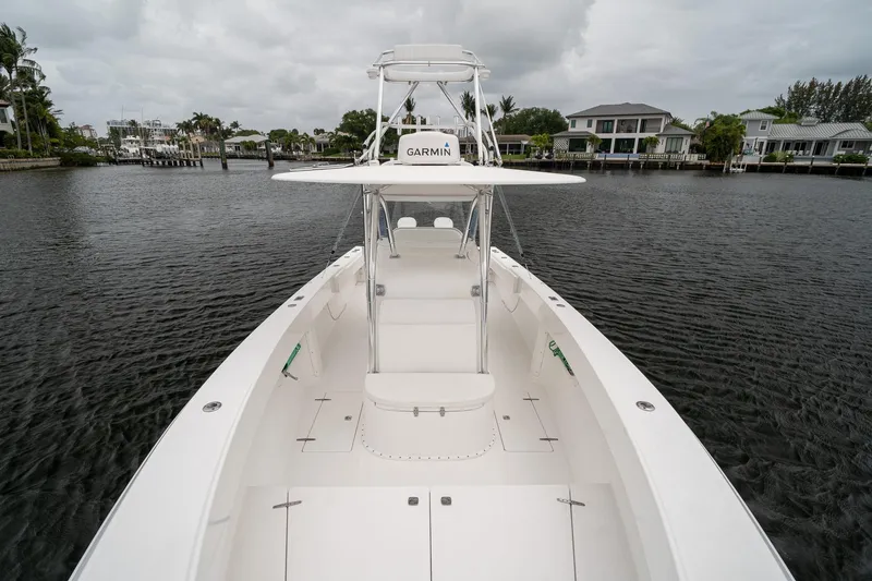 Slide: The Image of 2006 Venture Center Console boat on calm water, featuring Garmin equipment. - 14