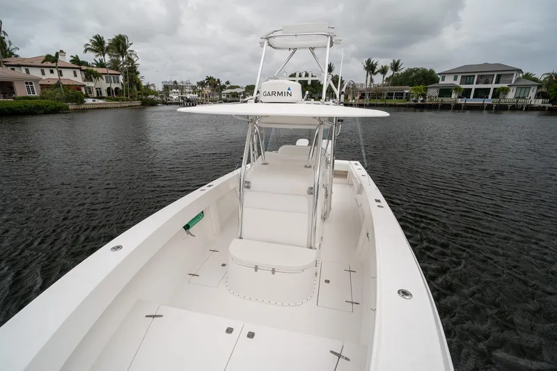 Slide: The Image of 2006 Venture Center Console boat on a calm waterway, surrounded by waterfront homes. - 15