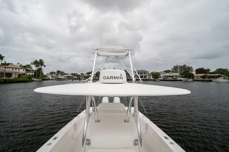 Slide: The Image of 2006 Venture Center Console boat with Garmin equipment on a calm waterway. - 18