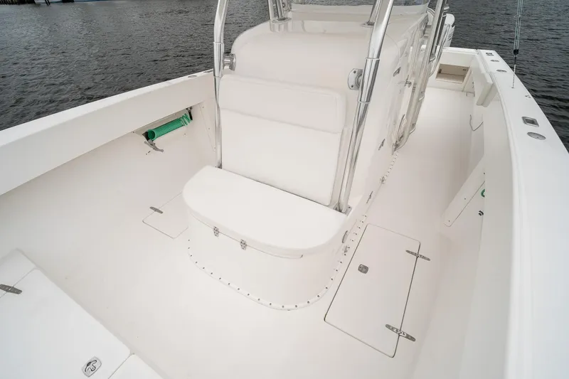 Slide: The Image of 2006 Venture Center Console boat interior with white seating and storage compartments. - 24