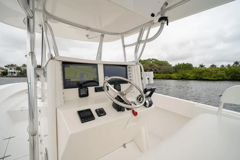 Slide: The Image of 2006 Venture Center Console boat interior with navigation screens and steering wheel. - 28
