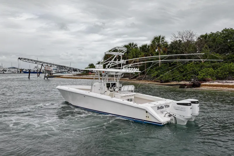 Slide: The Image of 2006 Venture Center Console boat with Suzuki engines near a tropical shoreline. - 3