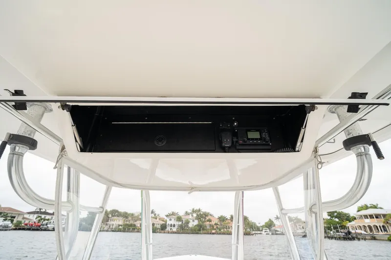 Slide: The Image of 2006 Venture Center Console boat electronics compartment with radio and controls. - 30