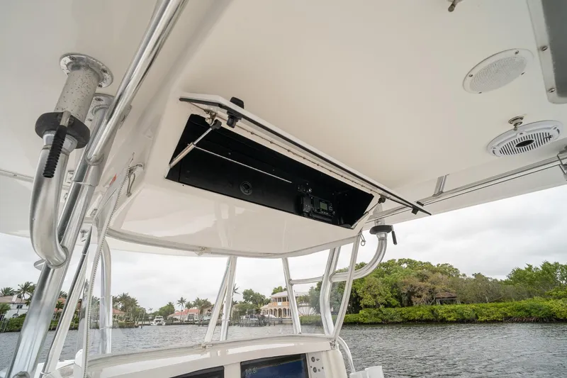 Slide: The Image of 2006 Venture Center Console boat interior with overhead storage and scenic waterway view. - 31