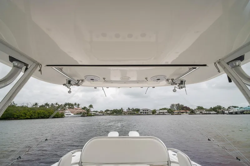 Slide: The Image of 2006 Venture Center Console boat on calm water, view from under the canopy. - 38