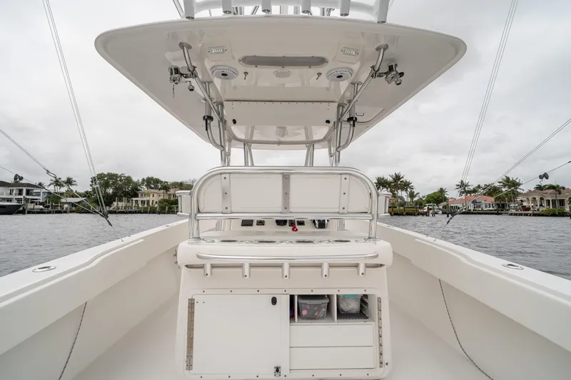 Slide: The Image of 2006 Venture Center Console boat interior with helm, overlooking waterfront homes. - 40