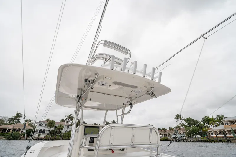 Slide: The Image of 2006 Venture Center Console boat with tower, docked near waterfront homes. - 41
