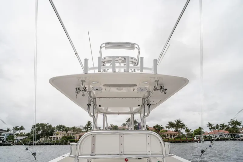 Slide: The Image of 2006 Venture Center Console boat with tower, viewed from below, against cloudy sky. - 42