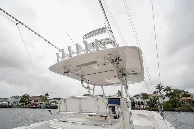 Slide: The Image of 2006 Venture Center Console boat with tower, docked near waterfront homes. - 44