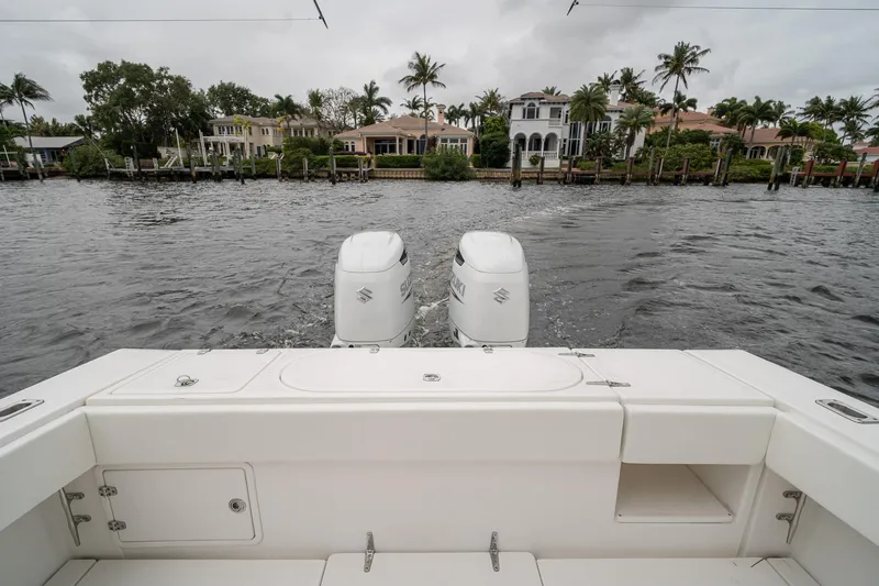 Slide: The Image of 2006 Venture Center Console boat with dual engines on a scenic waterfront. - 48