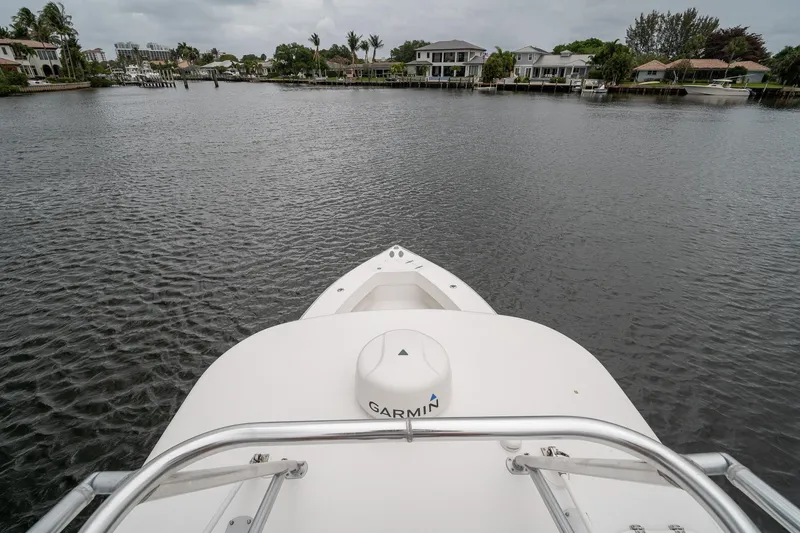 Slide: The Image of Bow view of a 2006 Venture Center Console boat on a calm waterway. - 51