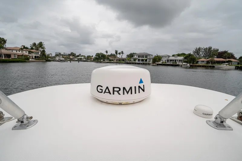 Slide: The Image of 2006 Venture Center Console boat with Garmin radar on a cloudy waterfront. - 52