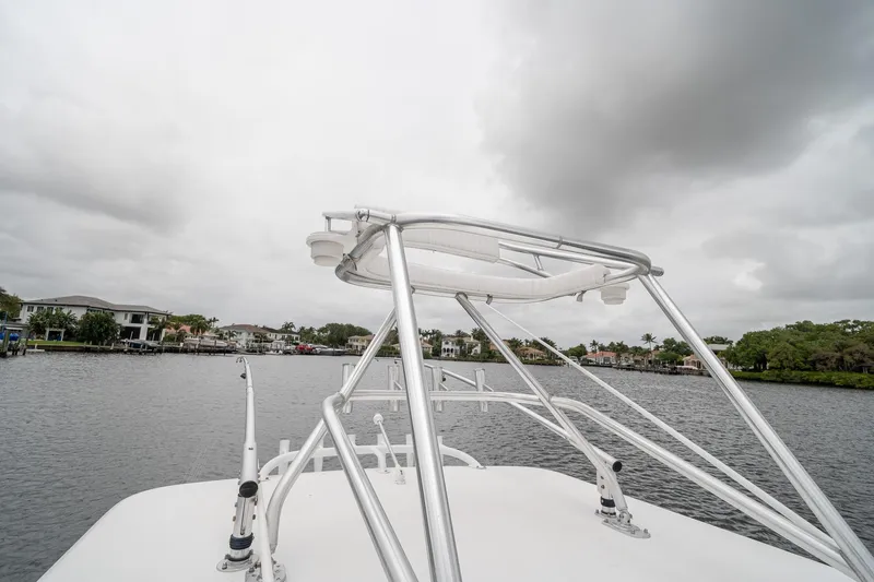 Slide: The Image of 2006 Venture Center Console boat on a cloudy waterfront, showcasing sleek metal framework. - 53