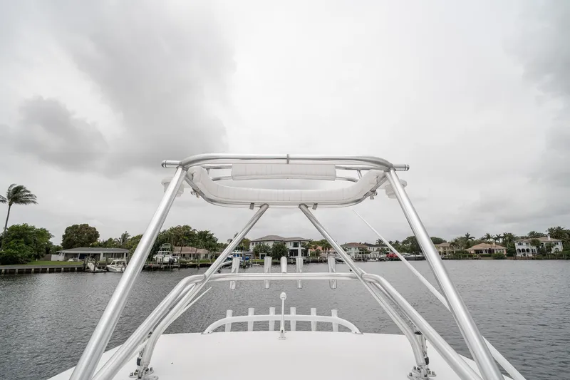 Slide: The Image of 2006 Venture Center Console boat on a calm waterway under cloudy skies. - 55