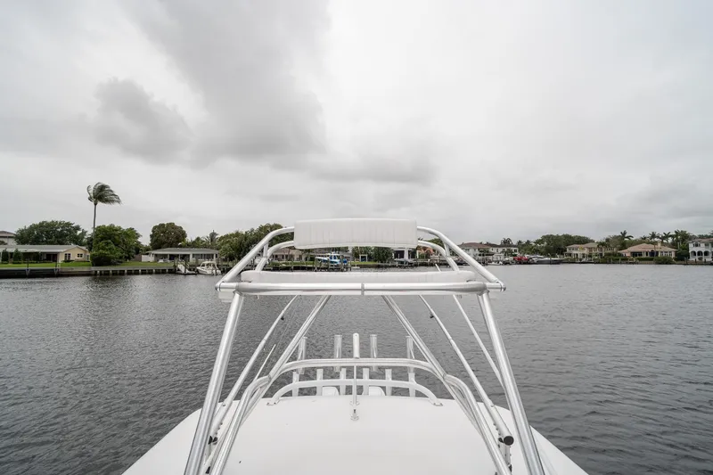 Slide: The Image of 2006 Venture Center Console boat on a calm river with cloudy skies. - 56