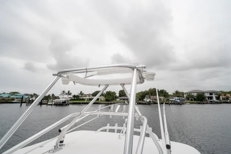 Slide: The Image of 2006 Venture Center Console boat on a cloudy waterfront, showcasing sleek design and sturdy structure. - 57