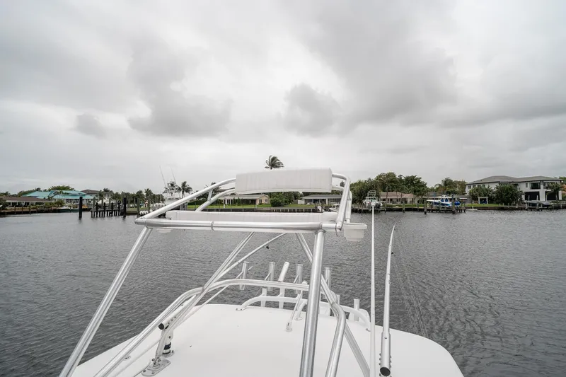 Slide: The Image of 2006 Venture Center Console boat on a calm waterway under cloudy skies. - 58