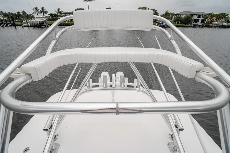 Slide: The Image of 2006 Venture Center Console boat with white seating and metal railings on a calm waterway. - 59
