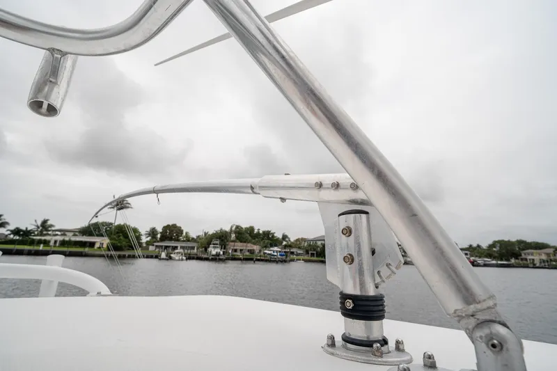 Slide: The Image of Close-up of a 2006 Venture Center Console boat's metal structure against a cloudy waterfront backdrop. - 61