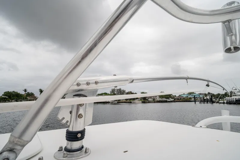 Slide: The Image of 2006 Venture Center Console boat with metal railings, overlooking a calm waterfront. - 62