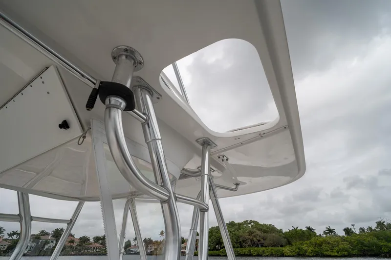 Slide: The Image of 2006 Venture Center Console boat with stainless steel T-top against cloudy sky. - 63