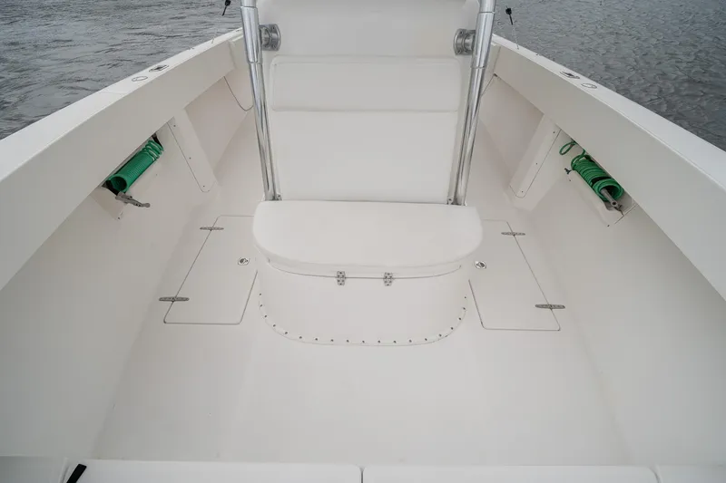 Slide: The Image of 2006 Venture Center Console boat interior with white seating and storage compartments. - 64