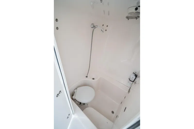 Slide: The Image of 2006 Venture Center Console boat bathroom with shower and toilet. - 65