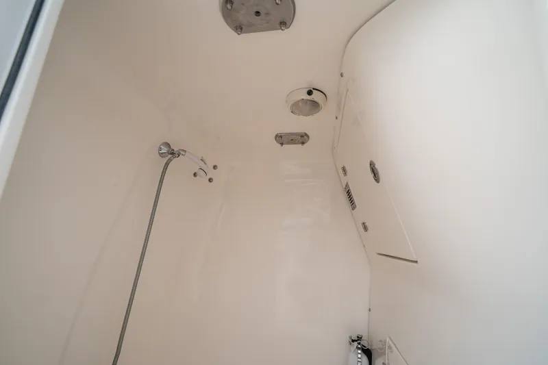 Slide: The Image of Interior of a 2006 Venture Center Console boat, featuring a compact shower area. - 66