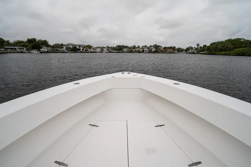 Slide: The Image of 2006 Venture Center Console boat on calm water under cloudy skies. - 9