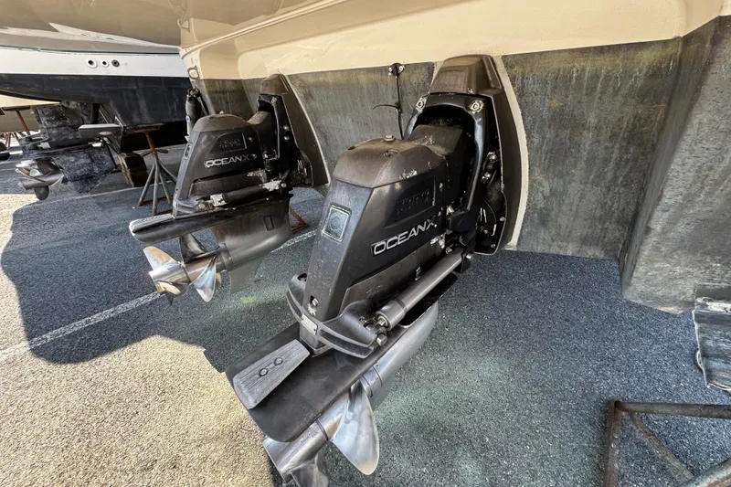 Slide: The Image of 2007 Monterey 330 Sport Yacht with OceanX outdrives, displayed on a dry dock. - 12