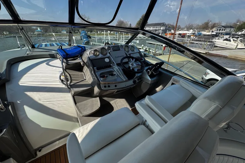 Slide: The Image of Cockpit of 2007 Monterey 330 Sport Yacht with steering wheel and navigation equipment. - 18