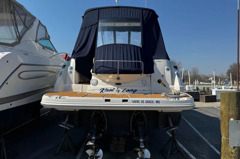 Slide: The Image of 2007 Monterey 330 Sport Yacht docked, rear view with blue cover, "Knot 4 Long" name visible. - 2