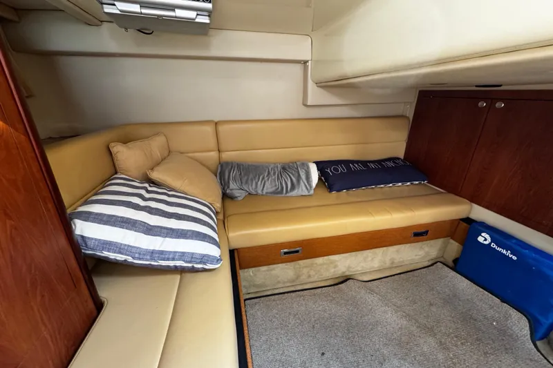 Slide: The Image of Interior of a 2007 Monterey 330 Sport Yacht with beige seating and cushions. - 28